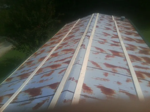 Rusted metal roof panels with new wood purlins before replacement — Storm Damage Roof Repair in Rayne by Roofing Brothers